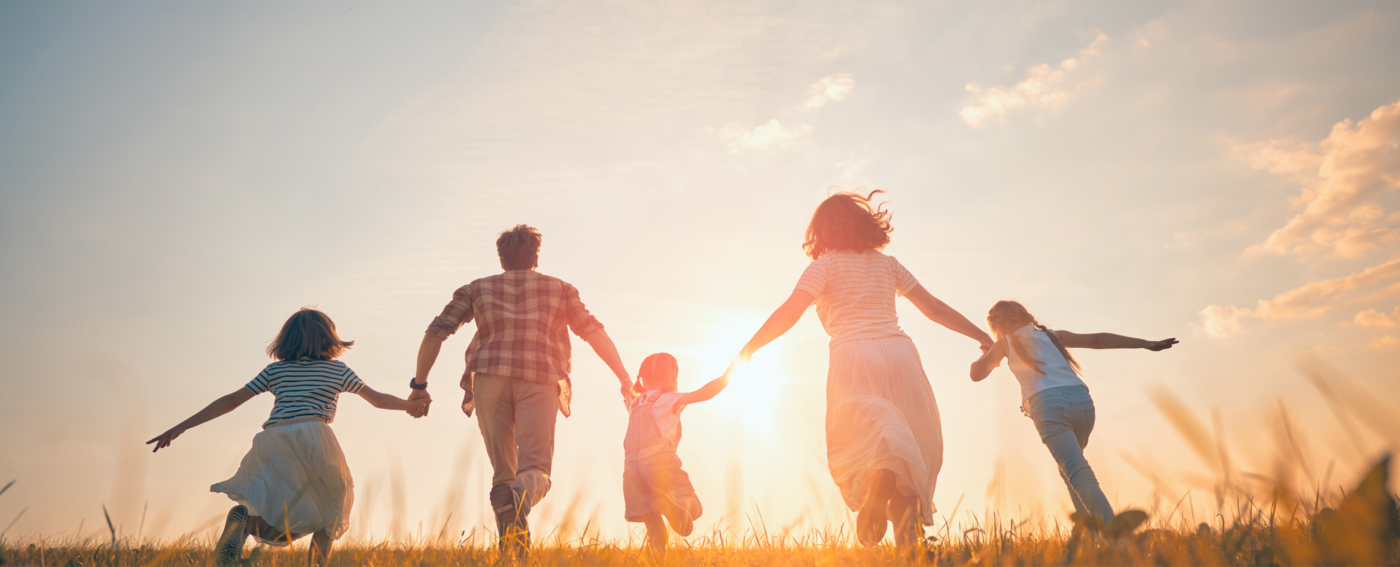 family holding hands and running